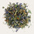 Sleep Incense Sweetgrass Lavender blend in white cylindrical container with dried herbs spilling out, ideal for restful sleep and stress relief.