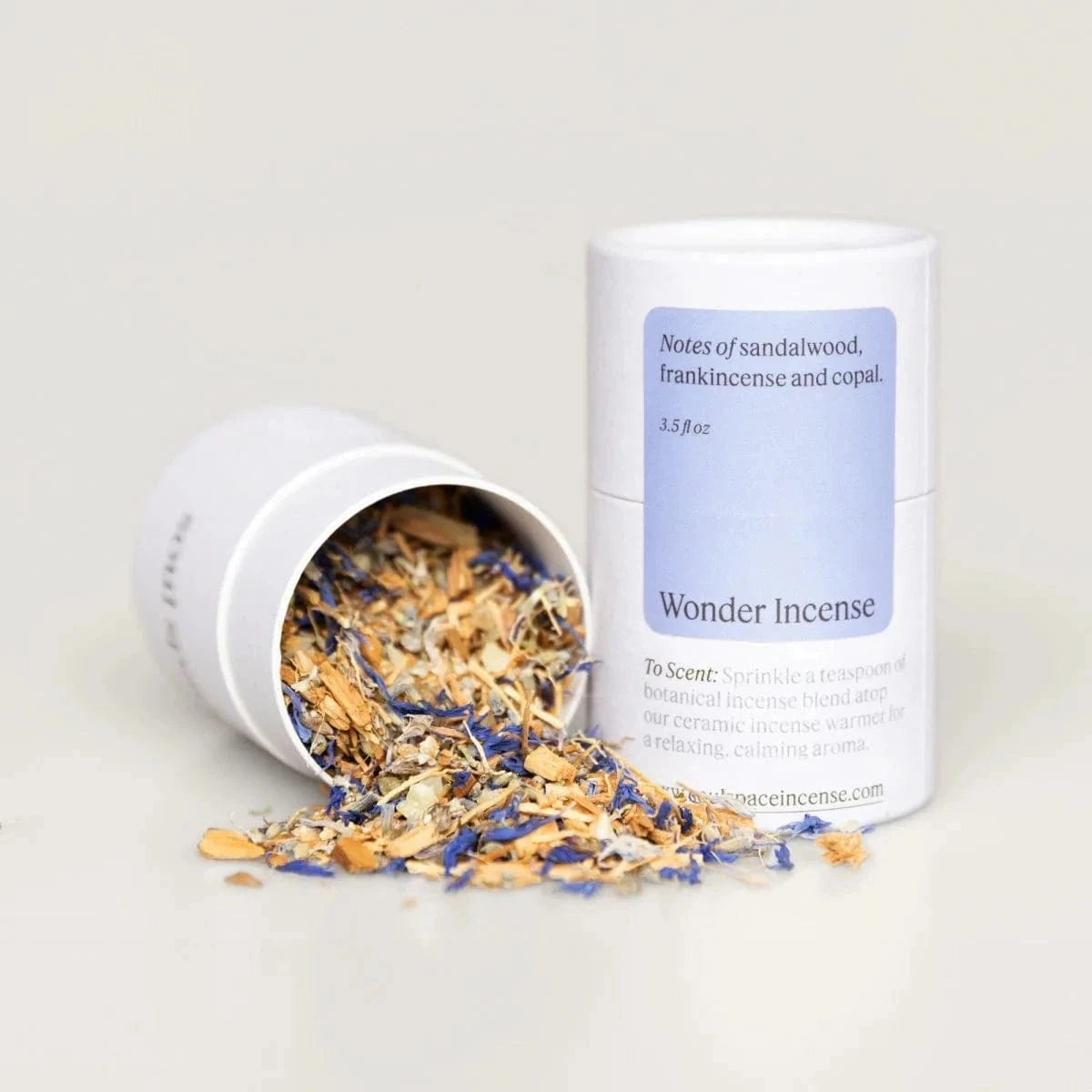 Wonder Incense - Frankincense Myrrh Luxury blend in a white cylindrical container with notes of sandalwood and copal, ideal for spiritual serenity.